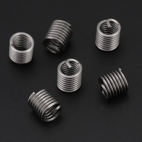 Coiled wire sleeve inserts from Premium SAE Thread Repair Kit With 60 Pcs 304 Stainless Steel for automotive repair.