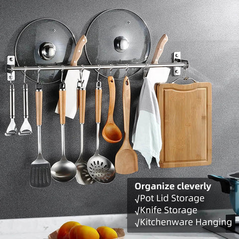 Utensil Hanging Rack Stainless Steel Rail Hanger Rod Wall Mounted Pot Pan Lid Holder Cookware Storage Organizer with Sliding Hooks for Kitchen Bathroom displaying utensils, lids, and a towel on a kitchen wall.