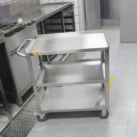 Three Tier Stainless Steel Utility Cart For Restaurant Hospital Lab And Hotel Use With Beefed Up Heavy Duty Wheels And Easy Handle Food Service Trolley 19W x 31L x 34H Treshin, shown in a kitchen setting.