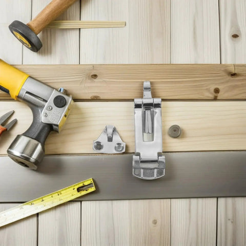 Stainless steel toolbox latch with mounting bracket on a wooden workbench