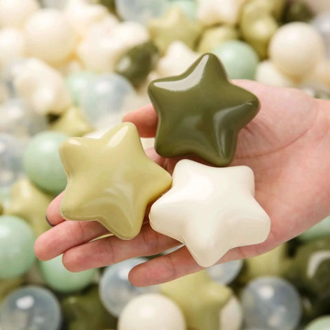 Hand holding green and cream star-shaped Ball Pit Balls 100 for Toddlers - Green Ball Pit Ball Shapes for Boys Girls Fun, Birthday Party, Christmas Decoration, Cream Colors Mix Green
