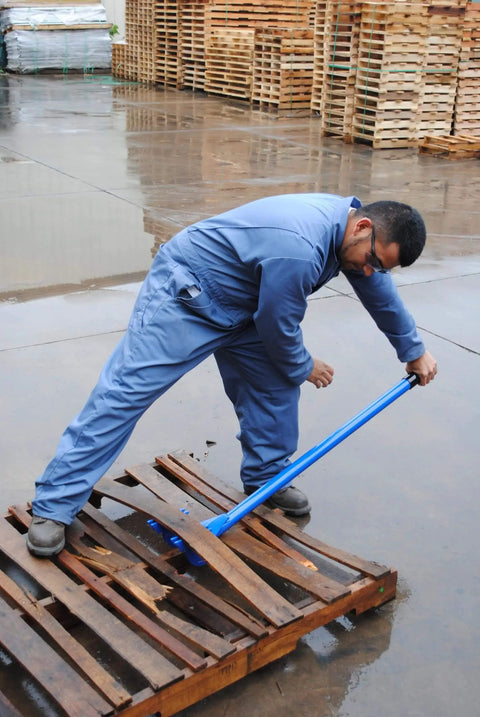 Worker using Deluxe Steel Pallet Buster With 41 Inch Handle For Easy Pallet Disassembly And Dock Board Removal, Heavy Duty, Blue