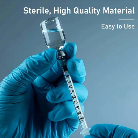 Gloved hands holding Disposable 1ml Syringe With Cap 31G One Quarter Inch 6mm Sterile Individually Packed Pack Of 20