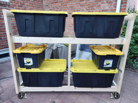 Wooden storage rack with black and yellow bins on 2 Inch Leveling Plate Caster Wheels With Adjustable Anti Vibration Leveling Feet.
