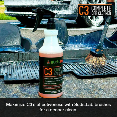 Suds Lab C3 Complete Car Cleaner bottle on car mat with brush, Multipurpose Car Wash Solution for Interior and Exterior Cleaning, 32 oz