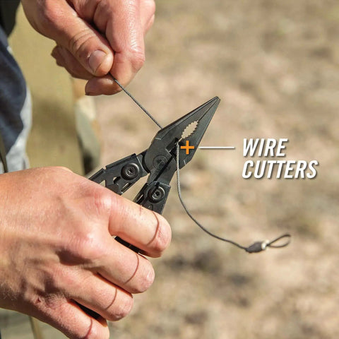 Hands using the Suspension-NXT 15-In-1 EDC Multi Tool with pocket knife, needle nose pliers and wire stripper outdoors.
