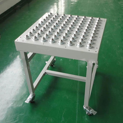 Table with multiple 5/8 Inch Swivel Ball Caster Roller Transfers Set of 6 Hardened Steel Ball Units Screw Mounted visible on surface.
