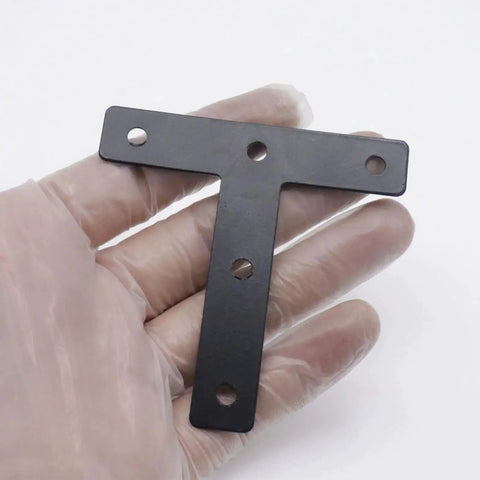 Person holding stainless steel T flat shape corner bracket 80x80mm for wood furniture fixing, part of 20 pack stainless steel T flat shape corner brackets 80x80mm mending plates for wood furniture fixing decorative corner supports durable stainless steel construction for long lasting strength and easy concealed install for furniture repair and renovation.