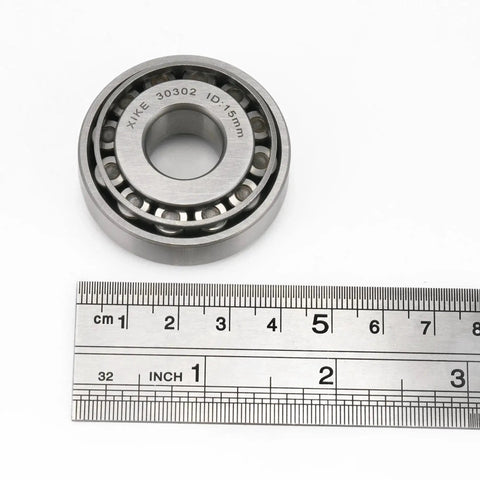 Two Piece 30302 Tapered Roller Bearing Cone And Cup Set 15x42x14.25mm with ruler for scale, chrome steel for cars and machinery