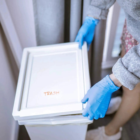 Person wearing Textured Blue Nitrile Gloves 5 Mil Powder Free Food Safe Large Box Of 100 handling trash lid