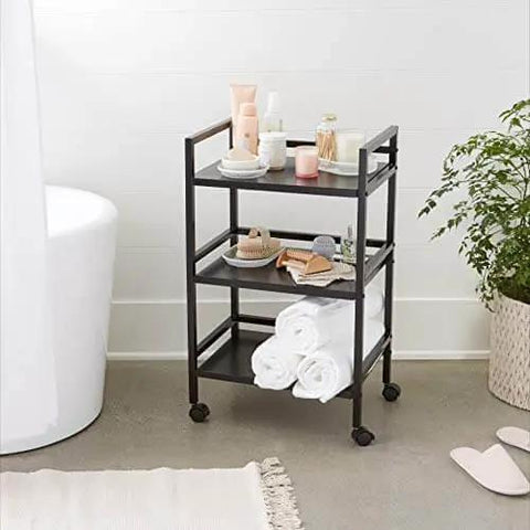 Three Tier Metal Rolling Utility Cart With Open Shelves For Quick Access And Grab And Go Mobility Ideal For Kitchen Bathroom And Workshop Durable Metal Construction In Black From Amazon Basics shown in bathroom setup.