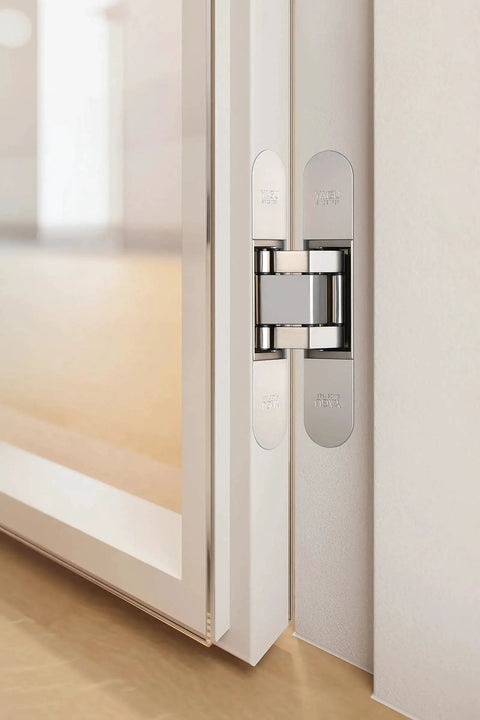 Three Way Adjustable Invisible Hinges For Hidden Doors, sleek zinc alloy, shown installed on a door, 180 degree swing, matte silver finish.