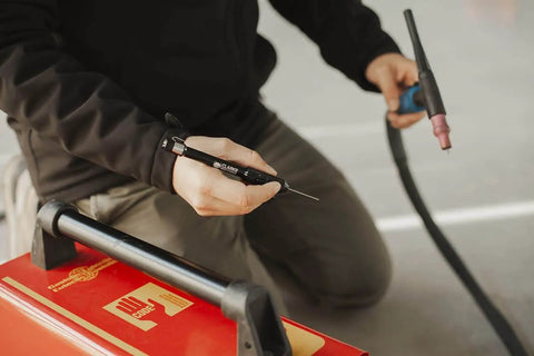 Person using Professional TIG Welding Pen Holder With Metal Storage Case And Comfortable Grip Welder Feeder Clip for precise welds