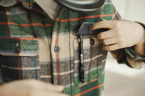 Person placing Professional TIG Welding Pen Holder With Metal Storage Case And Comfortable Grip into a plaid shirt pocket
