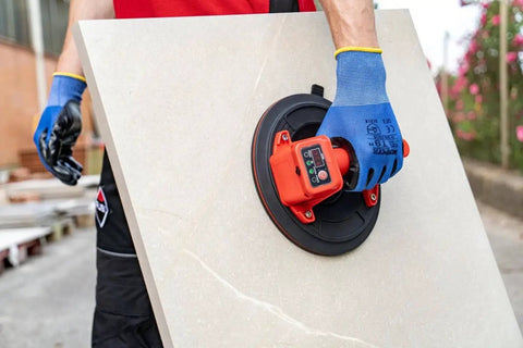 Battery Powered Tile Vacuum Suction Cup Tool for Handling Ceramic and Porcelain Tiles 220 mm grip in use by worker