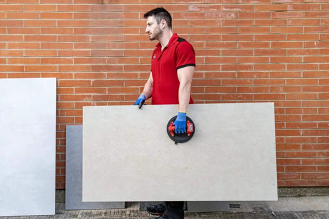 Man using Battery Powered Tile Vacuum Suction Cup Tool for handling large ceramic tile, 220 mm grip, 140 kg capacity