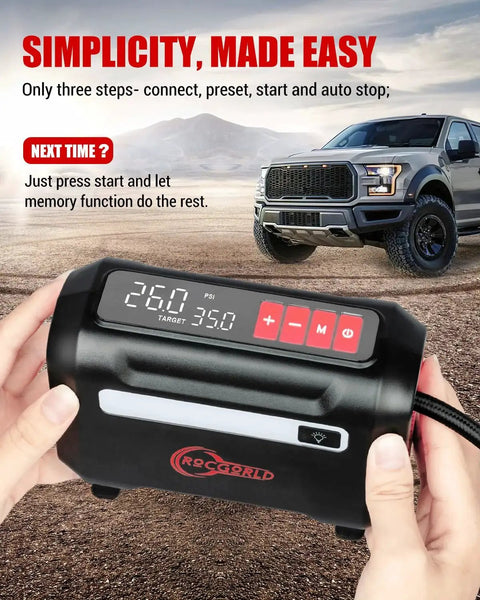 Hands holding R8 Tire Inflator Portable Air Compressor 12V DC with large dual digital screen, displaying pressure settings, truck in background.