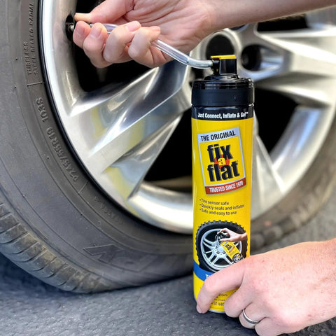 Aerosol Emergency Flat Tire Repair And Inflator For X Large Tires with eco friendly formula being used on car, 24 oz can visible