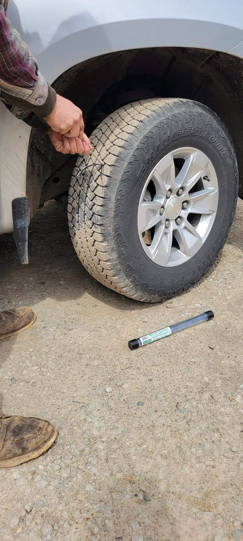 Heavy Duty Tire Repair Kit 21-Piece All-In-One Tire Plug Kit in use on car tire, showing repair on driveway surface.