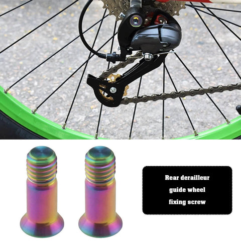 ECSiNG 2pcs Titanium Alloy Fixing Screws Bicycle Rear Derailleur Bolt Bicycle Derailleur Guide Wheel Fixing, shown near bike wheel