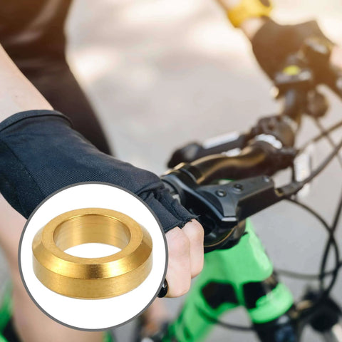 Cyclist gripping handlebar with inset of Partuto 4 Pcs M6x5.5 Universal Bicycle Bolt Brake Screw Washer Bolts in titanium alloy gold tone.