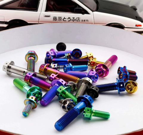 Colorful titanium bolts displayed in various colors with a background car model, aligned for showcasing design variety and appeal.