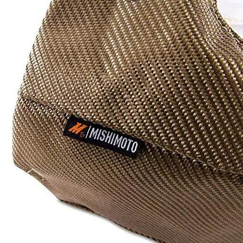 Close-up of Titanium Turbo Blanket T4 For Turbocharged Engines with lava rock outer layer showing Mishimoto label