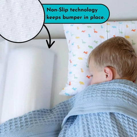 Child sleeping with Soft Foam Toddler Bed Bumper Guard With Non Slip Cover Safe Sleep Bed Rail Alternative visible on bed
