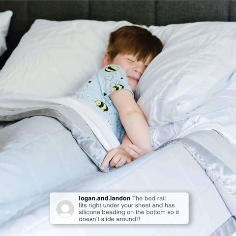 Extra Long Foam Bed Rails For Toddlers And Kids Water Resistant And Non Slip Guard Rails With Machine Washable Covers 2 Pack White Portable Bedside Safety Rails installed on bed with child sleeping