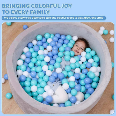 Child playing in ball pit with BPA Free Crush Proof Plastic Toy Balls for Ball Pit in white, green, and blue