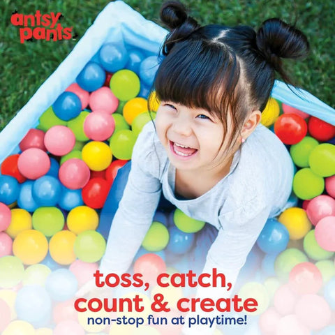 Toddler playing with 100 Ball Pit Balls in 5 colors, enjoying sensory toys for kids, in a ball pit for toddlers 1-3, with non-toxic materials.