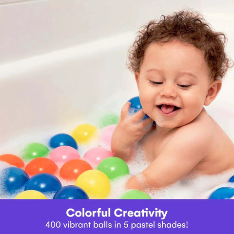 Young child playing with colorful plastic ball pit balls in bathtub, smiling. Ball Pit Balls for Kids, 200 Pack - Plastic Refill Balls.