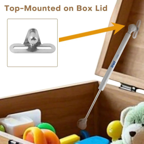 Two Pack Soft Close Toy Box Hinges With 150N Gas Strut for heavy curved lids installed on box, showing hinge and wooden box with toys.