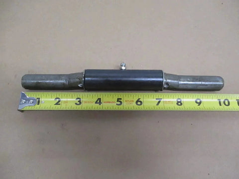 Single weld-on trailer ramp door hinge with integrated grease fitting next to measuring tape, 1x10 inch size, raw 9-gauge steel construction.