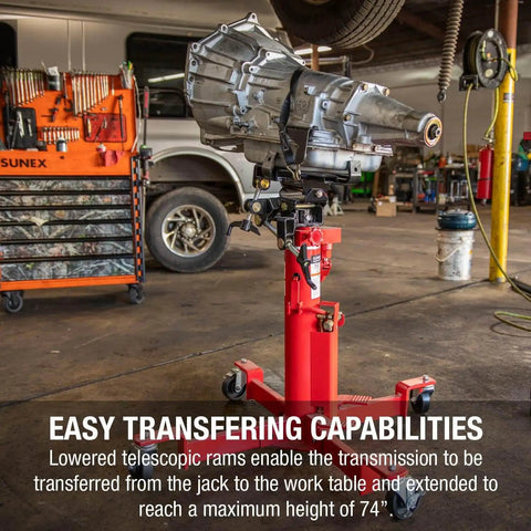 Beefy 1000 Lb Air And Hydraulic Telescoping Transmission Jack With Adjustable Saddle Arms, 35.5 In To 73.5 In Lift Range, Model 7796 For Transmissions, Transaxles And Transfer Cases In The Shop displayed in a mechanic shop with a transmission mounted.