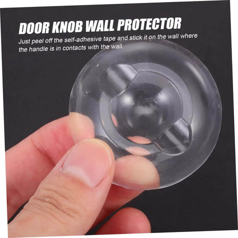 Hand holding a single transparent Six Piece Self Adhesive Door Bumper Set Quietly Absorbs Impact To Protect Walls And Doors Reduces Slams