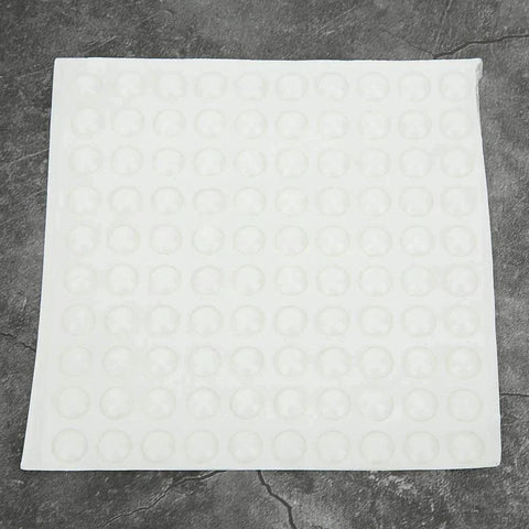 Sheet of Self Adhesive Anti Slip Silicone Bumpers 200 Pcs Transparent Foot Pads for Furniture and Glass Displays on dark surface