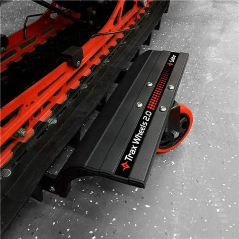 Trax Wheels 2.0 Rear Wheel Casters for Snowmobiles and Snow Bikes, installed under a vehicle, showcasing heavy-duty design.