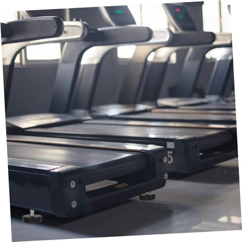 Treadmills with four piece adjustable treadmill feet mounting hardware with thumb screws installed, view of gym setup.