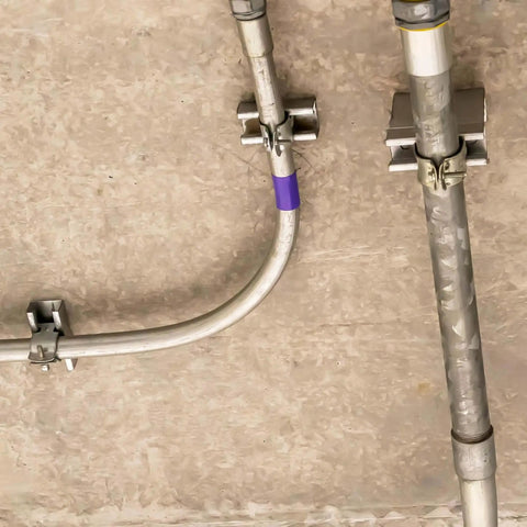 Installed ten-piece universal tube clamps deliver secure, corrosion-resistant support for Unistrut channels; 2 inch wall mount conduits