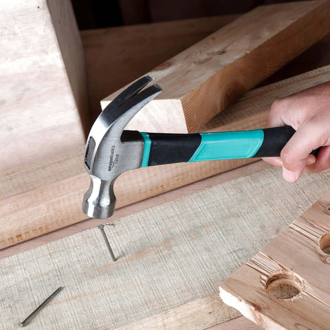 104 Piece Home Repair Tool Set With Easy Carrying Pouch For DIY Projects And Everyday Fixes Includes Hammer Pliers Magnetic Screwdrivers And Bits Wrenches Utility Knife Level And More In A Turquoise Portable Kit hammer in use driving a nail into wood