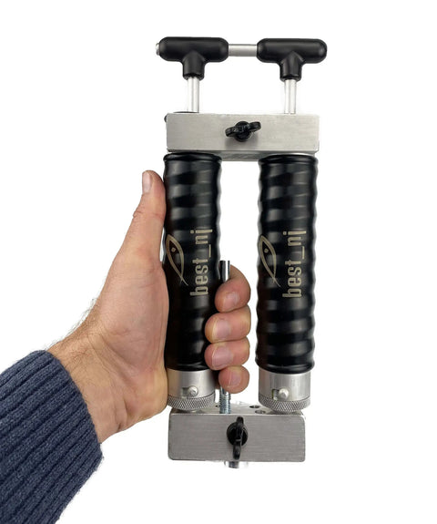 Hand holding Twin 120 Milliliter Aluminum Injector Mixing Set for soft plastics, featuring twin reservoirs and locking nozzle.