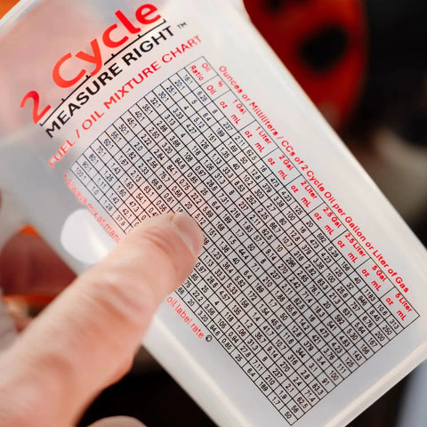 Close-up of Two Stroke Oil Measuring Cup 16 Oz Mixing Pitcher With 15 In 1 Ratio Conversion Chart for power tools.