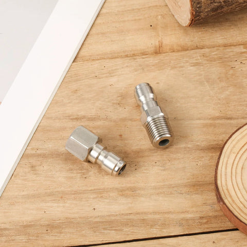 Two stainless steel 1/4-inch fast-connect pressure washer fittings with internal and external threads.