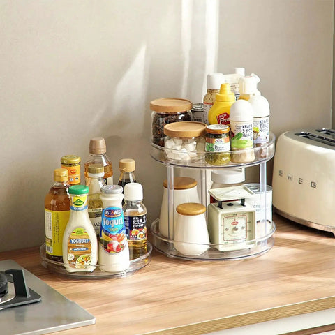 Two Tier Clear Lazy Susan Turntable Organizer With 360 Degree Rotation on kitchen counter, holding spices and condiments