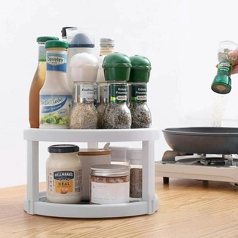 Two Tier Rotating Lazy Susan Organizer with Non Skid Base holding condiments and spices on kitchen countertop, 10 inch turntable.