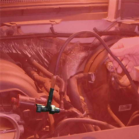EasyConnect EVAP leak detection kit adapter connected to engine bay; hand holding hose and metal connector
