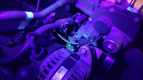 REALHUNLEE automotive AC UV dye leak detector kit with 68-LED UV flashlight and protective glasses in an engine bay.