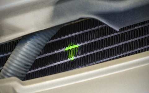 LEAKFINDER LF3001CS coolant dye applied to car radiator fins; neon green UV fluorescent trace