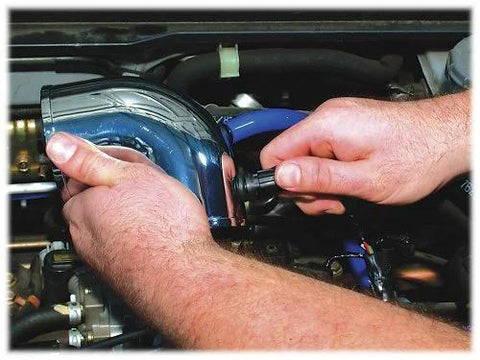 Spectre Performance 8711 vacuum sensor adapter kit installation in engine bay; blue aluminum adapter with blue hose.